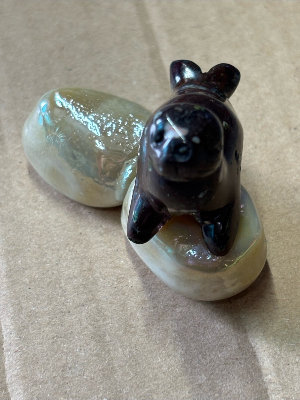 Stones of Giant Otter Colored Seal on Iridescent Cream Stones